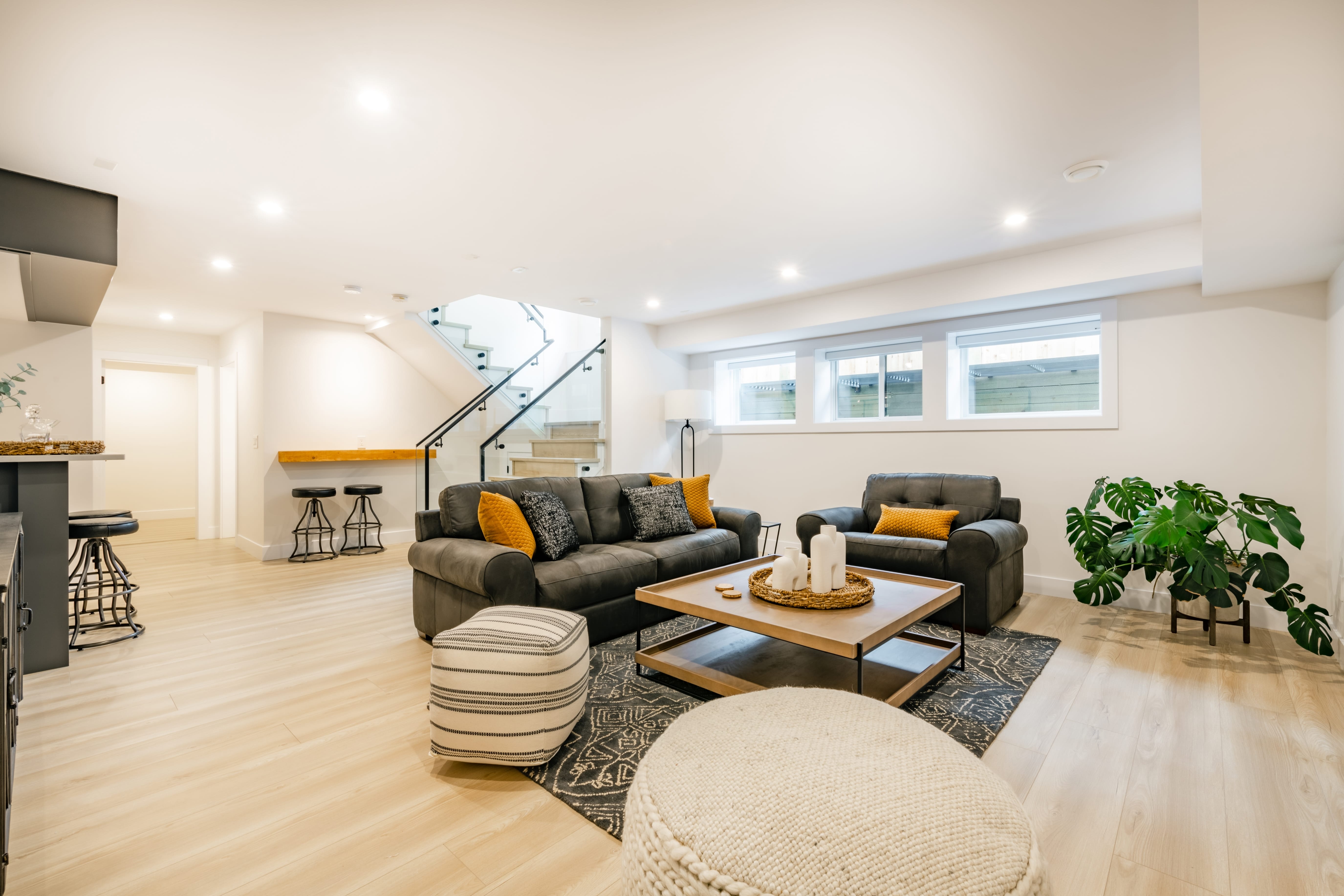 recreation,party,room,with,bar,stairs,with,glass,rails,downstairs